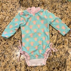 Turquoise turtles long sleeve one piece rash guard.